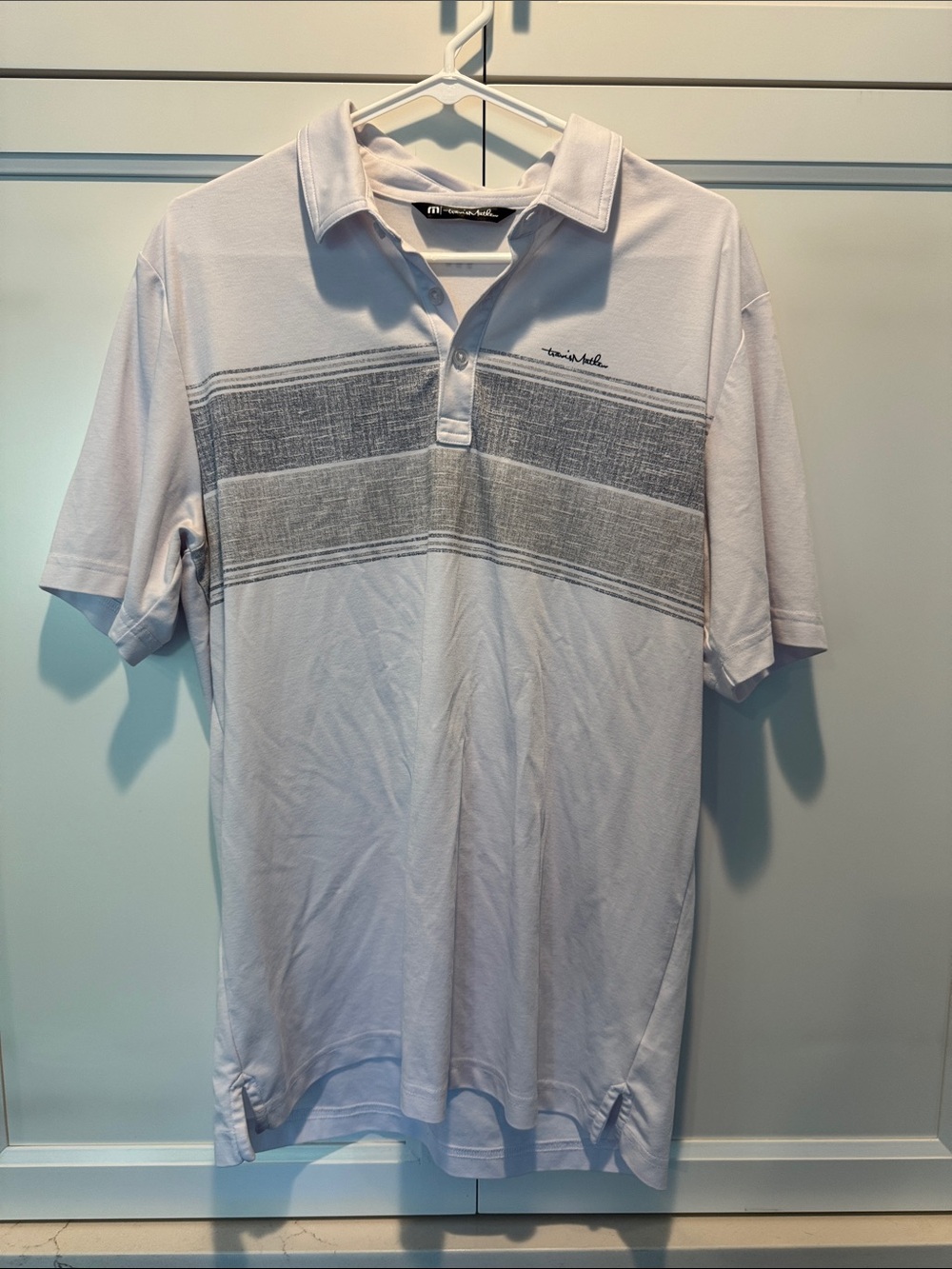 Travis Mathew White Polo with Gray Horizontal Chest Stripe